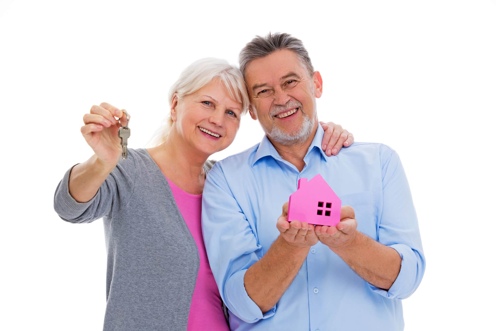 couple holding model of house after timing their home move