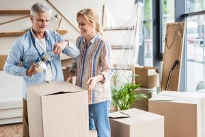 Couple packing up for downsizing to smaller home